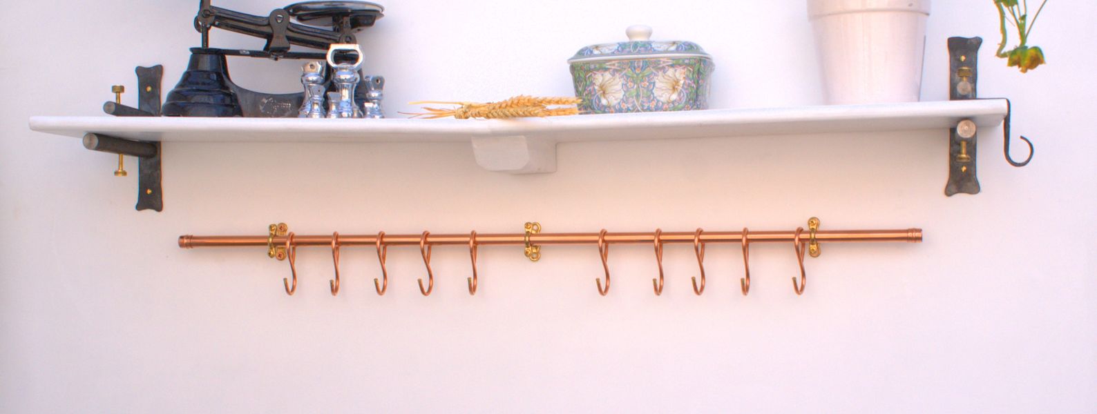 Rustic wall-mounted copper pan rail with 10 French-style hooks