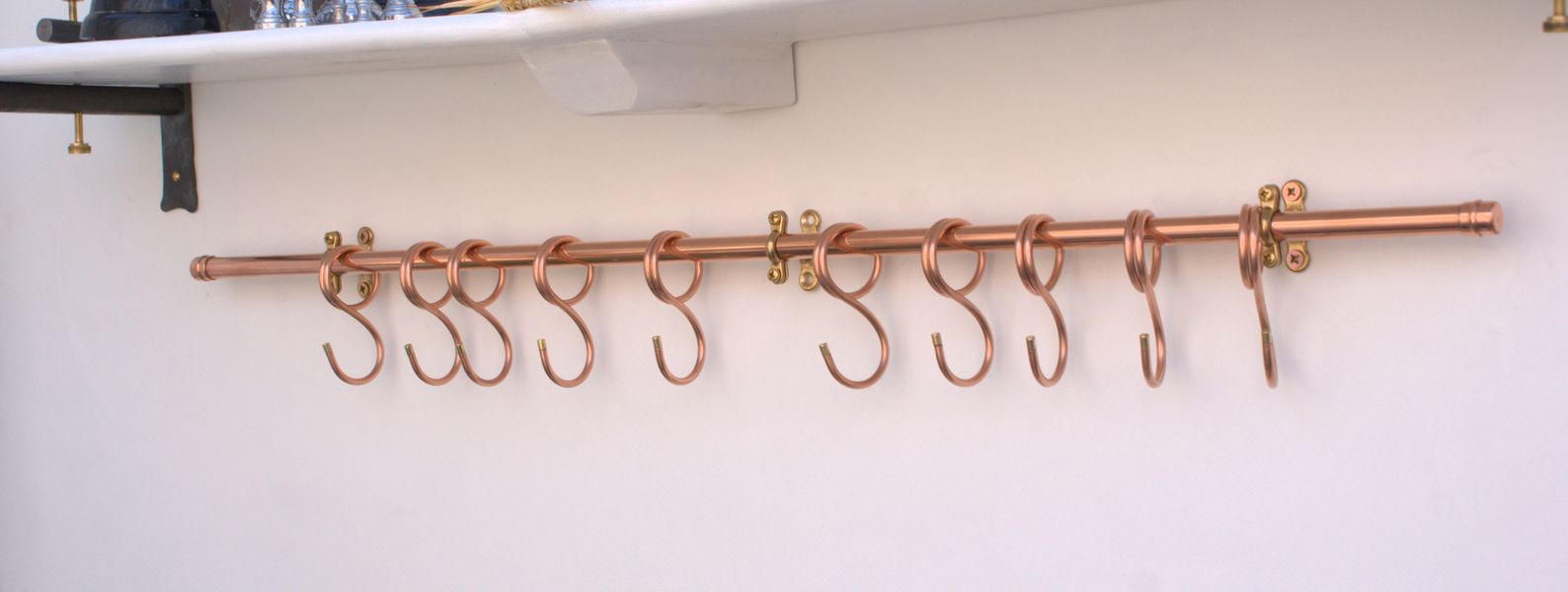 Wall-mounted long copper pan rail in sleek modern design