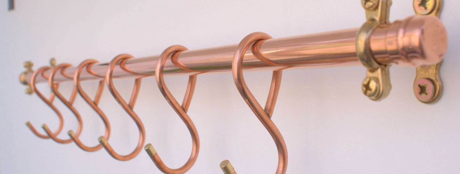 24-inch copper pan rack with six French-style hooks, hand-forged and wall mounted