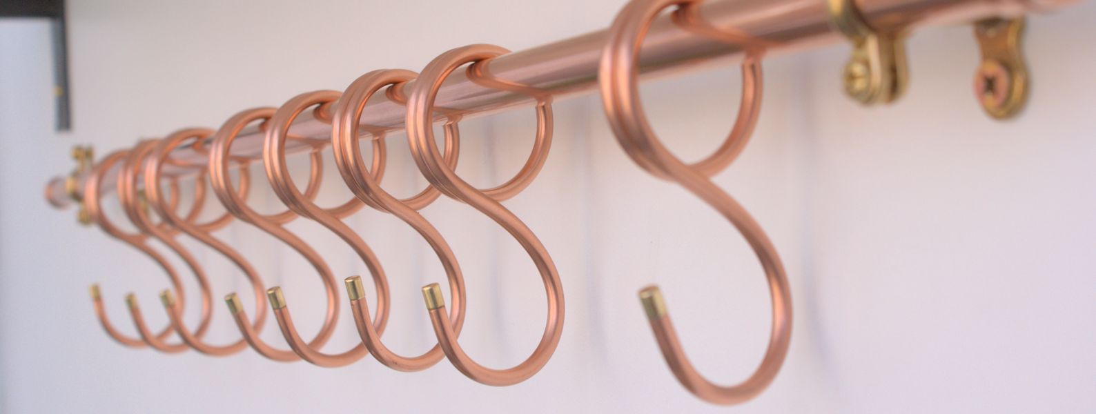 Contemporary copper kitchen rail for wall-mounted storage