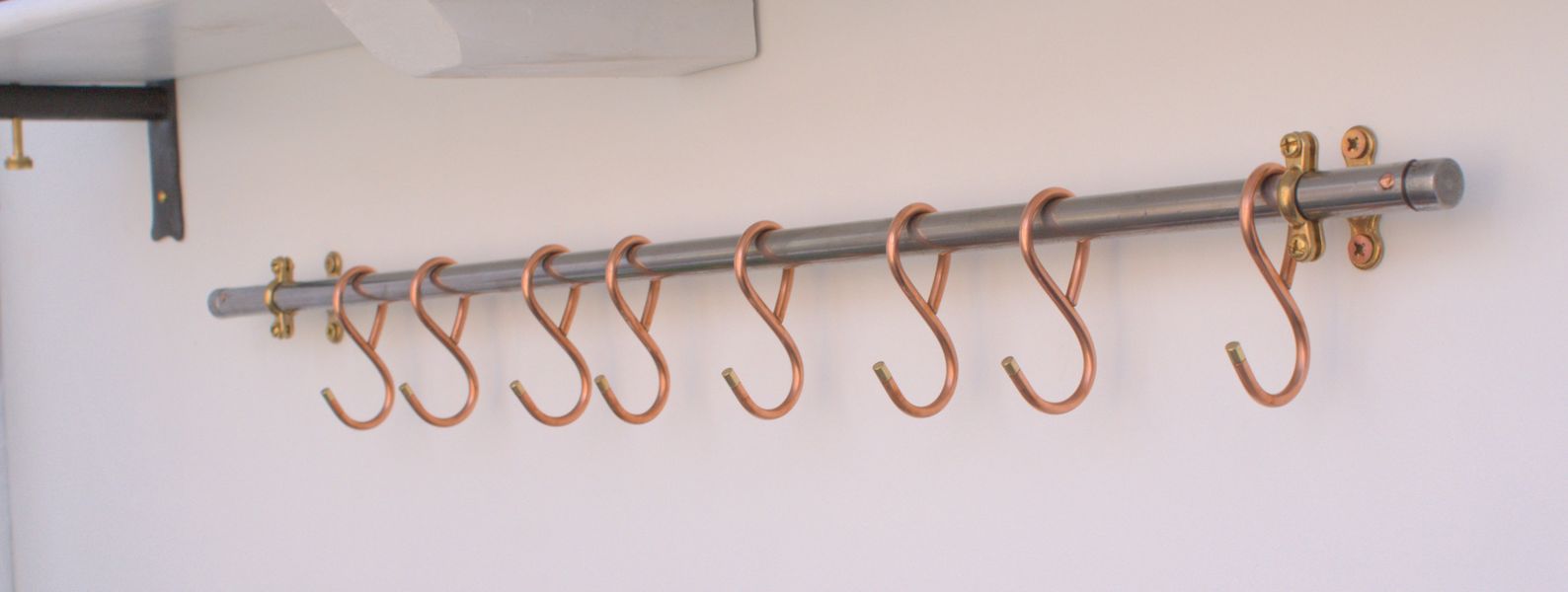 French-style copper hooks on 31-inch wall-mounted steel rack